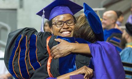 Professor hugging a graduate
