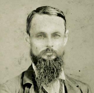 A black and white portrait of TCU founder Randolph Clark, a middle-aged bearded man, in 1874.