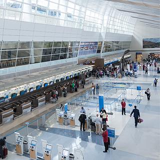 The ticketing counters inside a Dallas-Fort Worth International Airport terminal that features four-story-tall ceilings with abundant natural light